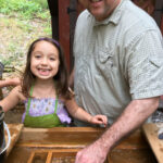 girl and her dad sifting for gems