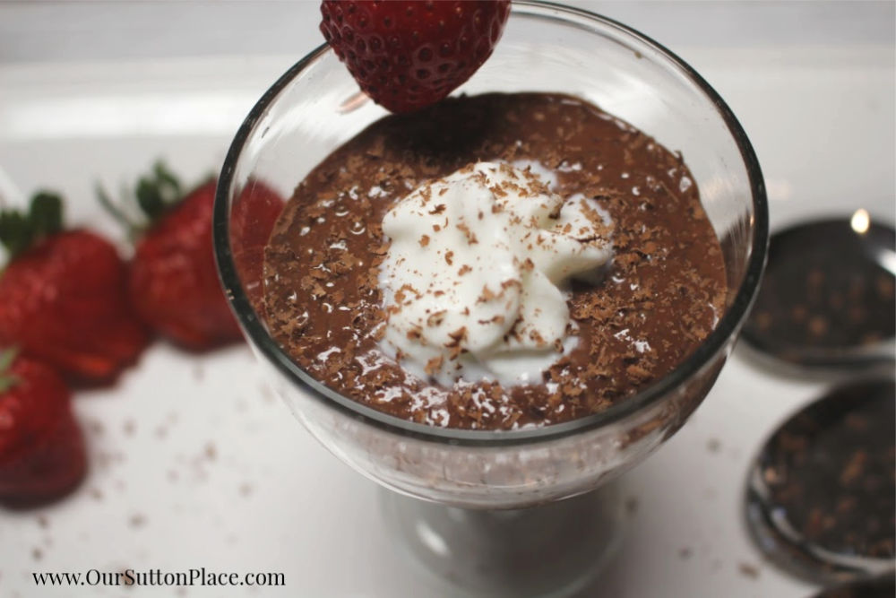 close up chocolate strawberry chia seed pudding in glass