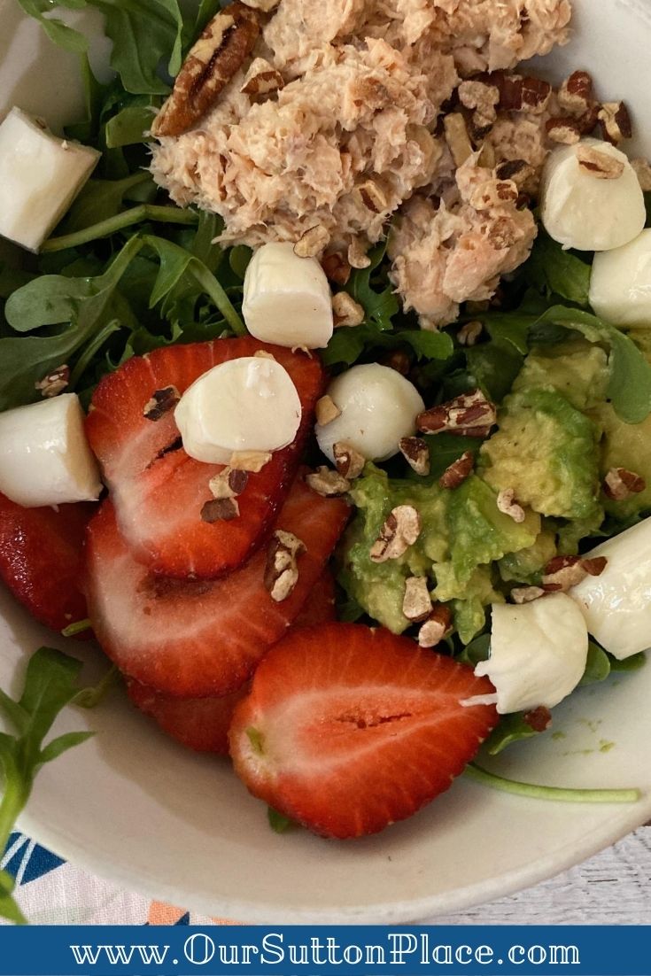 closeup view of the Strawberry Summer Salad with strawberries, arugula, mozzarella, avocado and canned salmon