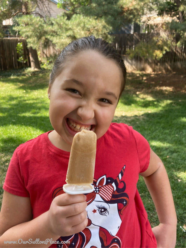 girl eating root beer float smoothie popsicle