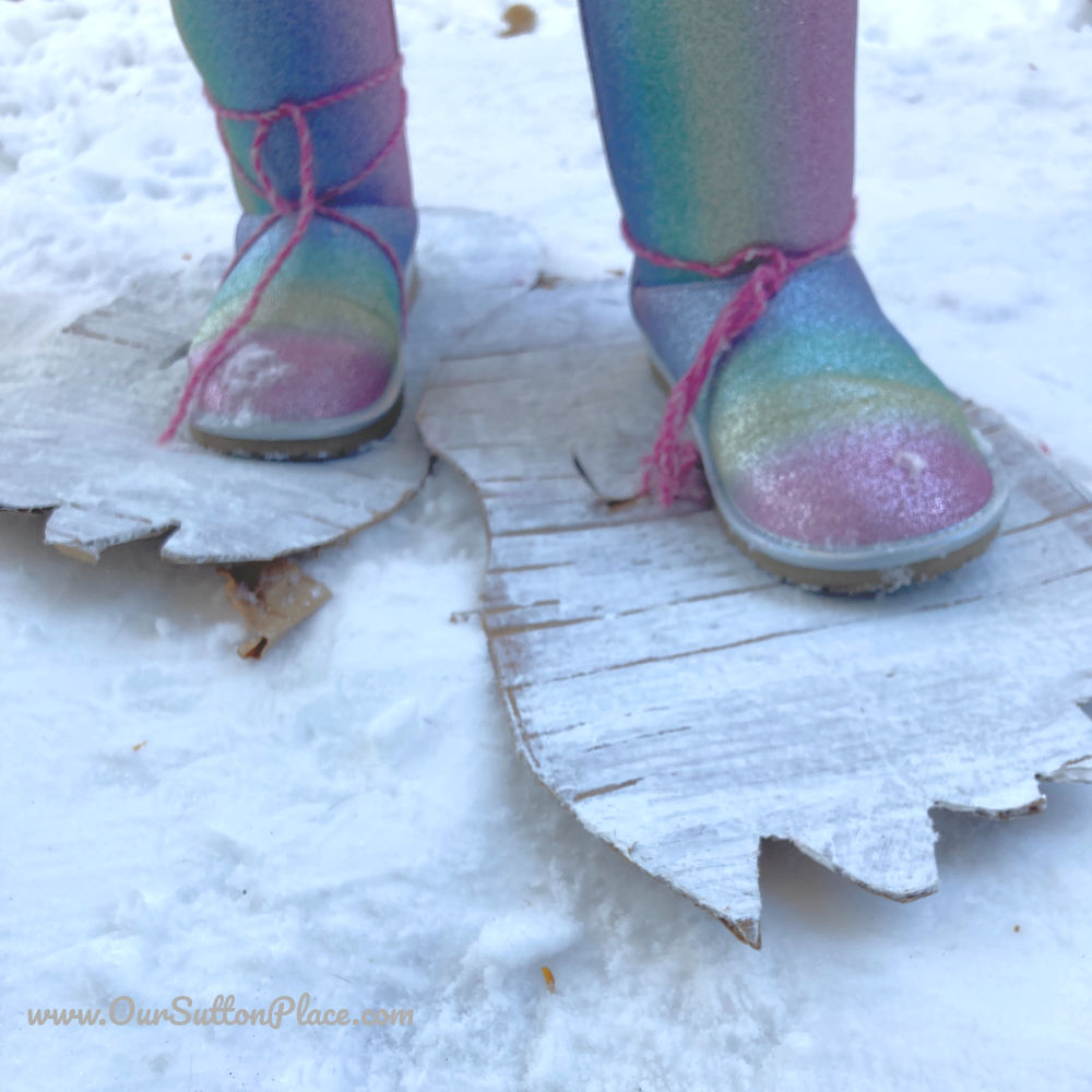 closeup of white cardboard sasquatch feet with person standing on them