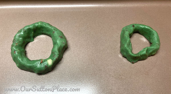 Green cookie dough shaped like a Christmas Wreath 