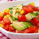 Tomato, Avocado, Corn Salad in a white bowl